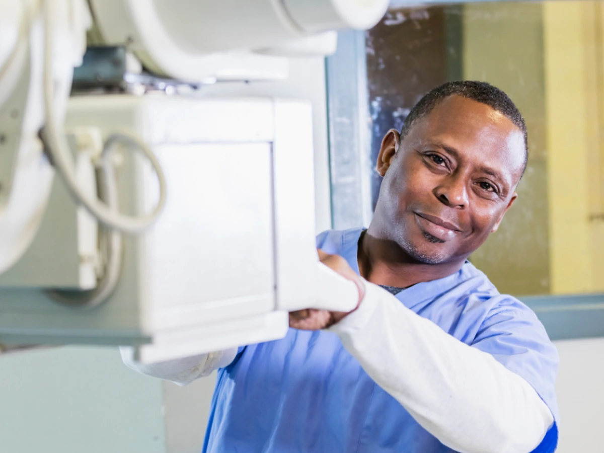 X ray technologist positioning imaging equipment